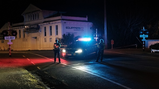 Masterton, New Zealand – July 30, 2022: A nite view of New Zealand Police hold a road block during a raid.