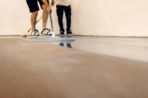 istock Closeup shot of worker applying floor primer with a special tool 1437527585