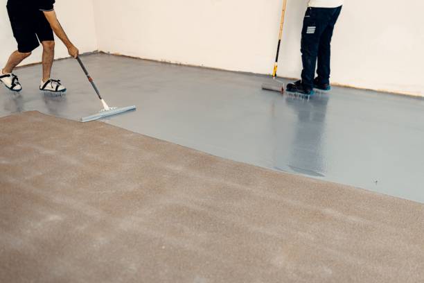 istock Construction workers applying grey epoxy resin in an industrial hall 1437527627