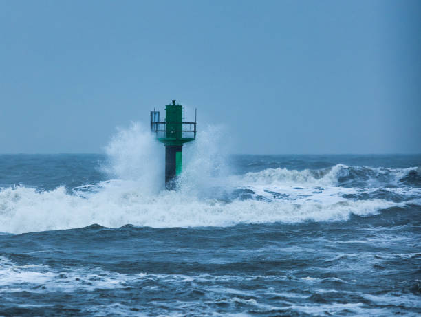 istock Lighthouse being hit by the waves of the sea 1437527645