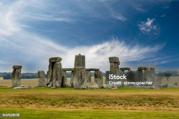 Whispy Clouds In A Blue Sky Behind The Stone Circle At Stonehenge A Unesco World Heritage Site Near Amesbury In Wiltshire England Stock Photo - Download Image Now