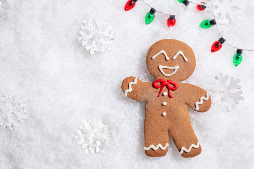 Cute Gingerbread man for Christmas card. Cozy concept of Christmas and winter holidays. Top view.