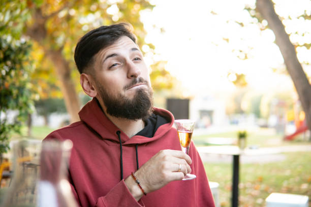 Caucasian guy sitting at a table in a cafe drinking