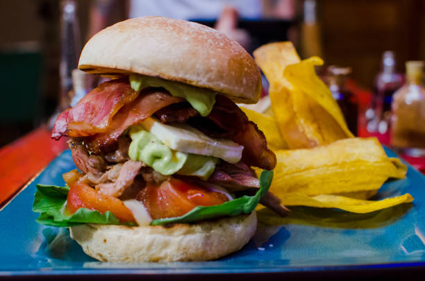 istock Shallow focus closeup shot of a hamburger with potato chips on a table 1437533729