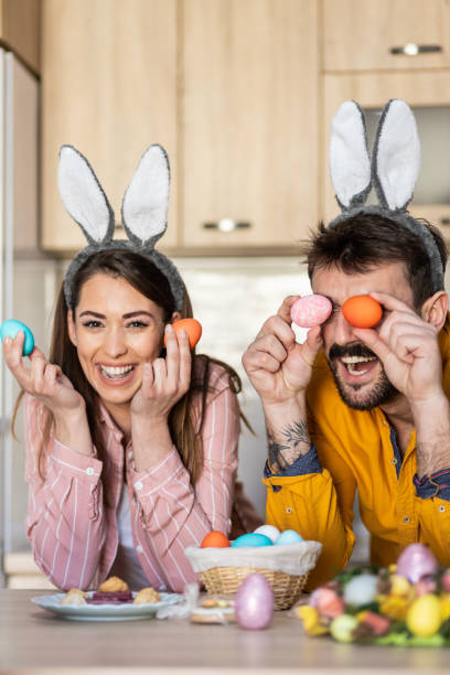 istock Happy young couple goofing around with Easter eggs 1437534523