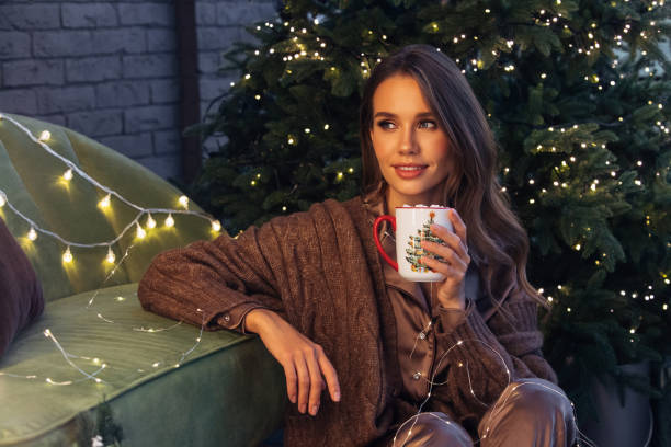 istock Woman sitting among Christmas atmosphere 1437536337