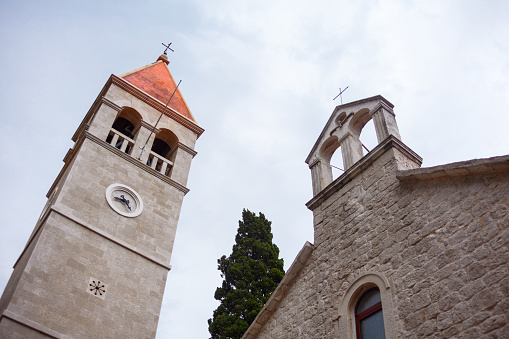 Medieval belfry and steeple . Church of the Assumption of the Blessed Virgin Mary in Slatine Croatia . Church tower with clock