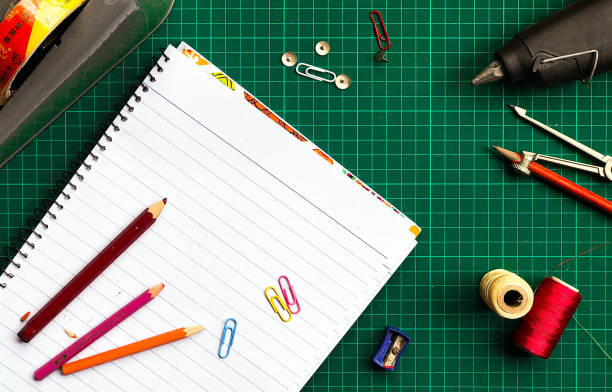 istock Top view of a green gridded desk with various stationery 1437537542