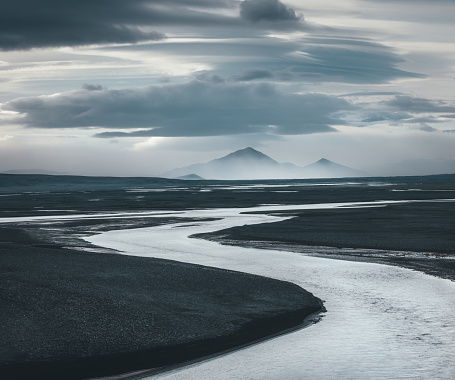 Winding river flowing through the majestic Icelandic landscape.