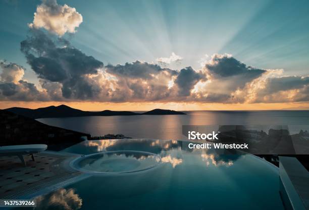 Scene From A Fancy Resort Luxury Pool To The Lagoon At Sunset Stock Photo - Download Image Now