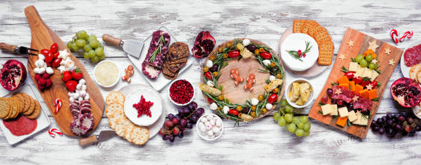 istock Christmas charcuterie table scene over a white wood banner background 1437540166