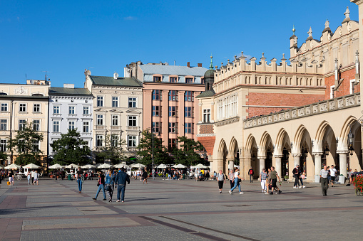 Cracow, Poland - September 1, 2022: Tourists walking on Market Square in  Cracow, Poland.