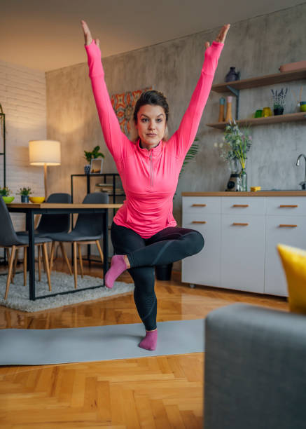 istock Woman practicing yoga at home 1437545833