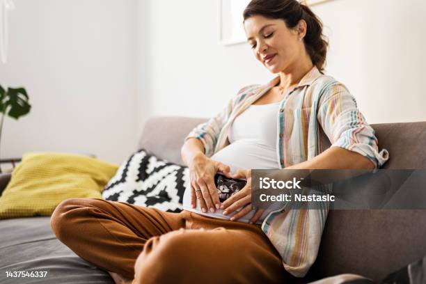 Smiling Pregnant Woman Holds Hands In Heart Shape Stock Photo - Download Image Now - 20-29 Years, 30-34 Years, Abdomen