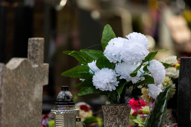 istock Flowers on graves in the cemetery during the All Saint's Day. 1437547540