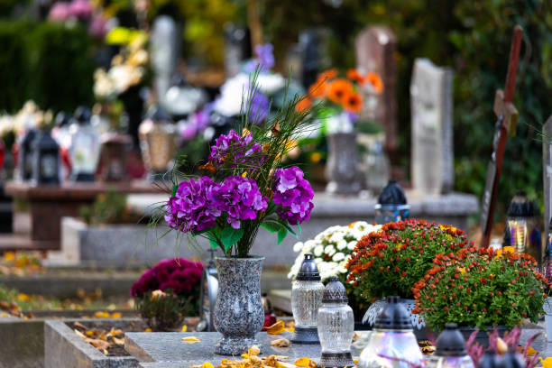 istock Candles and flowers on graves in the cemetery during the All Saint's Day. 1437547584