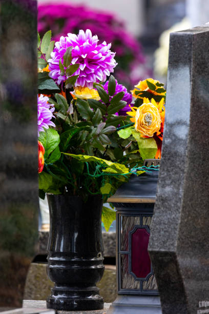 istock Flowers on graves in the cemetery during the All Saint's Day. 1437548152