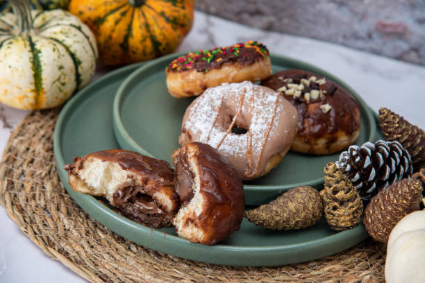 istock Halloween Pumpkins and Colorful Donuts 1437548181