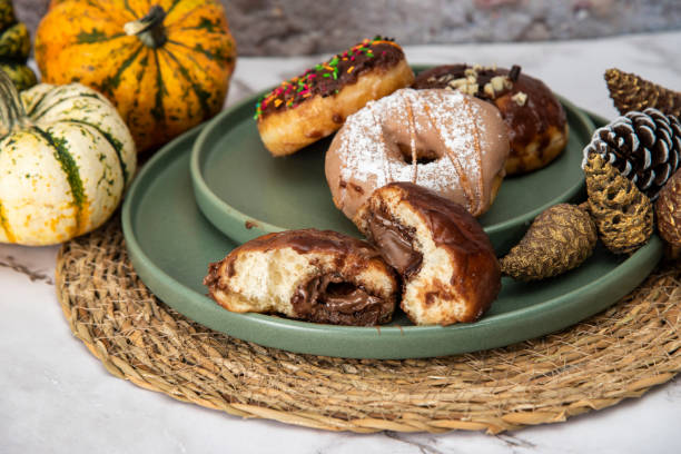istock Halloween Pumpkins and Colorful Donuts 1437548257