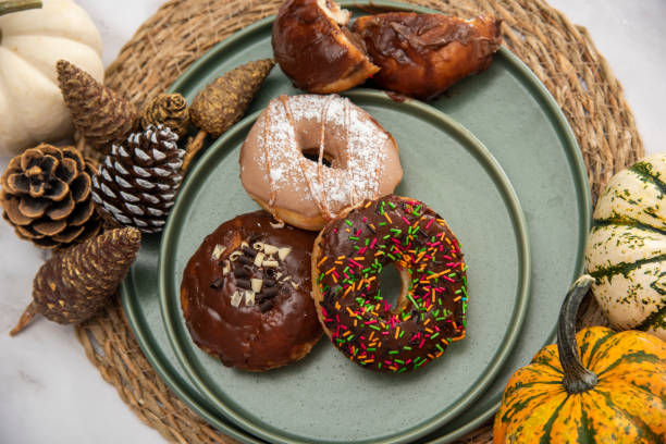 istock Halloween Pumpkins and Colorful Donuts 1437548516