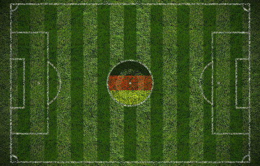 A top view of a soccer field with the flag of Germany in the middle of the field