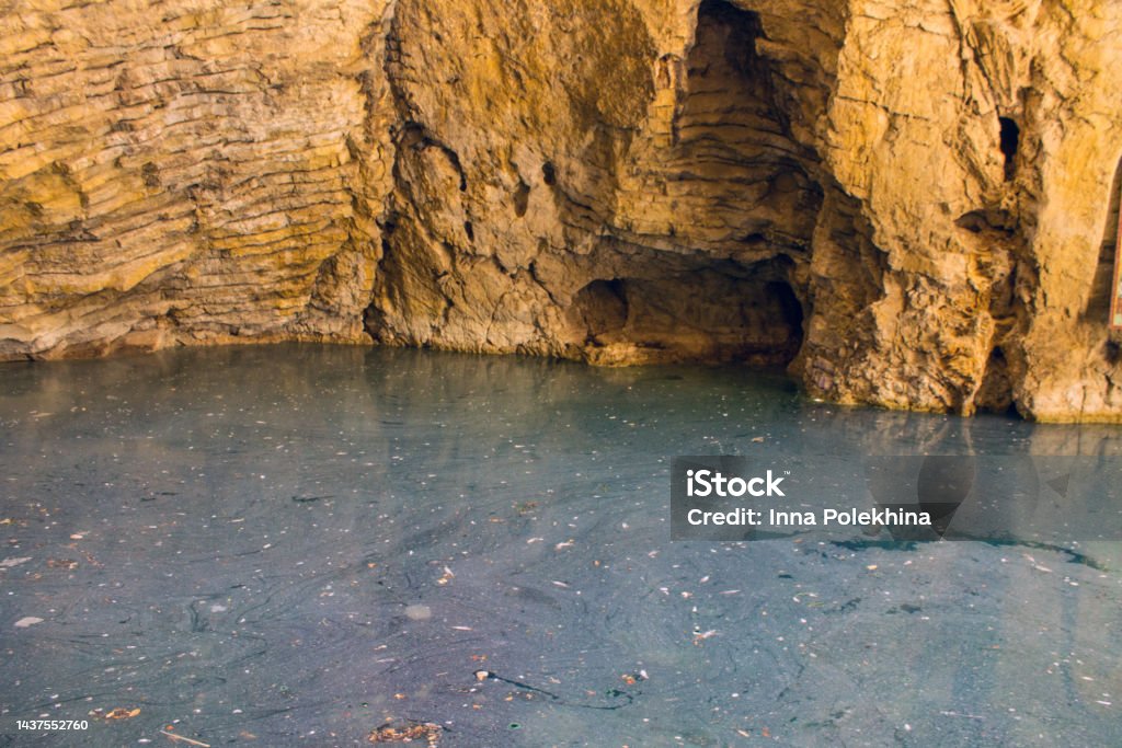 underground lake is a sinkhole in Pyatigorsk The famous underground lake is a sinkhole in a cave with stone walls in Pyatigorsk Stavropol Territory Russia on a sunny day Architecture Stock Photo