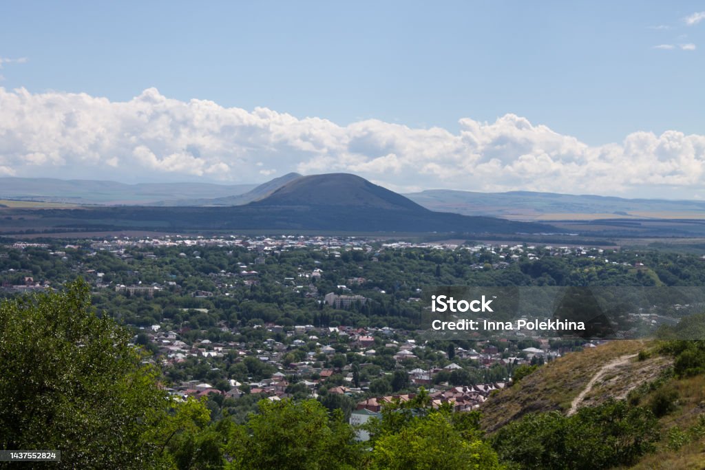Panoramic view of Pyatigorsk Panoramic view of Pyatigorsk in the Stavropol Territory with tasks among green trees and a mountain against the background of a dramatic cloudy sky on a summer day Adventure Stock Photo