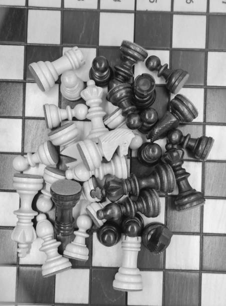 istock Black and white wooden figures for chess on the board 1437554446
