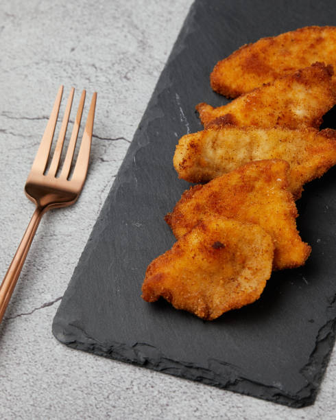 istock Top view of appetizing crispy fried chicken pieces with a fork 1437555082