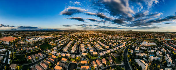 Neighborhood Sunset Pano Aerial panorama over a neighborhood in Gilbert, Arizona, facing east. The Superstition and San Tan Mountains can be seen in the distance. chandler arizona stock pictures, royalty-free photos & images