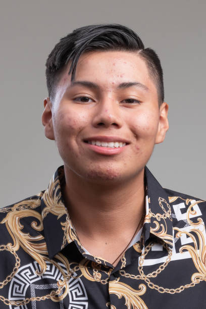 istock Smiling Hispanic teenage boy on gray background 1437556921