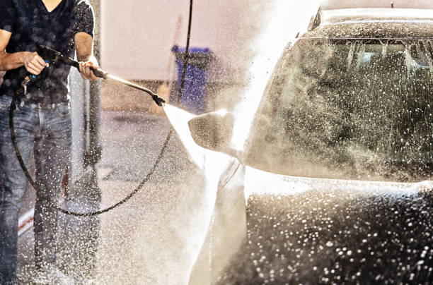 istock Man Washing Car at Carwash 1437558432