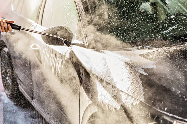 istock Man Washing Car at Carwash 1437558433