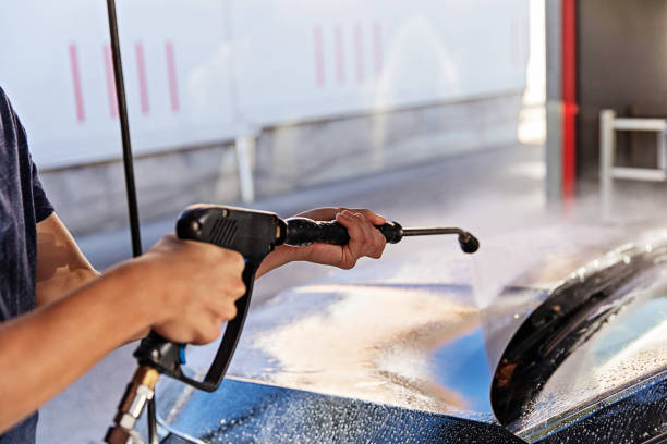 istock Man Washing Car at Carwash 1437559325