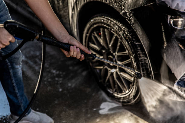 istock Man Washing Car at Carwash 1437559328
