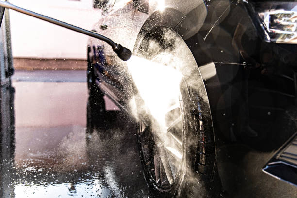 istock Man Washing Car at Carwash 1437559347