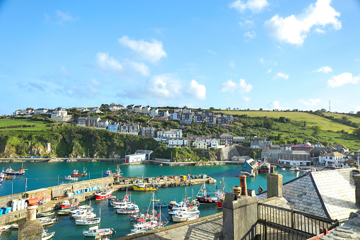Mevagiss, United Kingdom – July 05, 2020: Mevagissey, Cornwall, England / UK - July 5, 2020: View of Mevagissey Harbour on a sunny Summer day with colourful fishing boat. Cornwall, UK