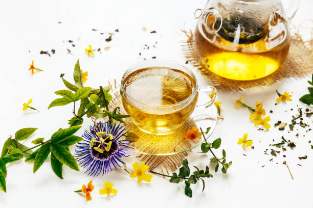 Calming herbal tea with the leaves of the passion flower Calming herbal tea with the leaves of the passion flower on white background passion flower stock pictures, royalty-free photos & images