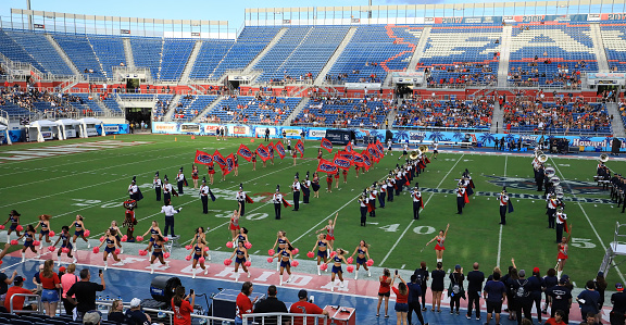 Boca Raton, Florida, USA - October 14, 2022:  Florida Atlantic University (FAU) Marching Band and Cheerleaders performs in the pre game between Texas Rice University Owls and Florida Atlantic University Owls.