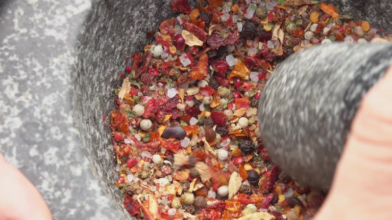 The pestle crushes the mixture of peppers