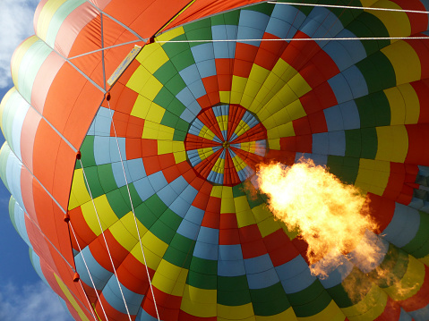 A flame ignites inside a balloon, providing the hot air it needs for flight.