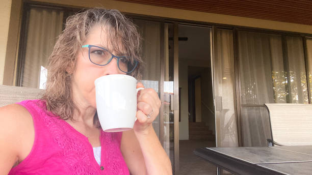 istock Mature woman sitting with coffee cup 1437572983