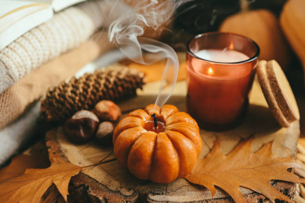 istock Smoke from an extinguished candle and a cup of tea, autumn composition 1437575882