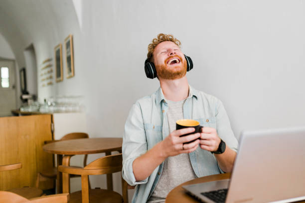 istock Ginger businessman using laptop and having video call at coffee shop 1437576871