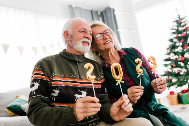 istock Senior couple holding numbers 2023 while celebrating New Year 1437578287