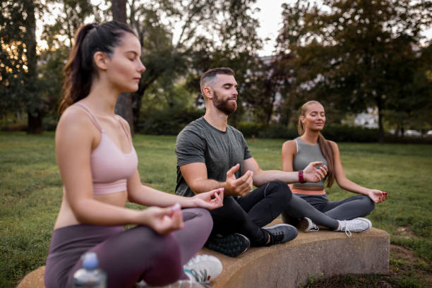 istock Three people meditating outdoors 1437578437