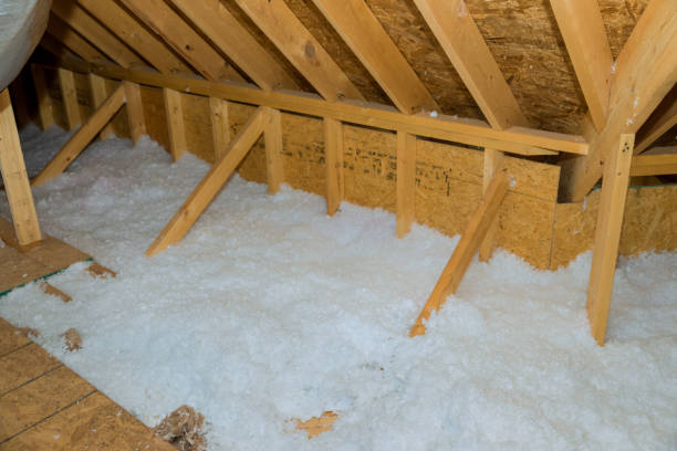 A new homes attic insulation roof is being poured with eco wool insulation for the purpose of insulating it stock photo