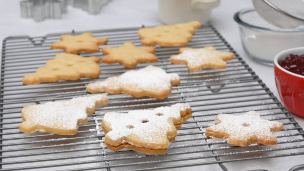 istock Christmas shortbread cookies with raspberry jam recipe, close up baking process. Baked cookies close up on cooling rack 1437581041