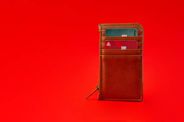 Brown wallet with cards on a red background