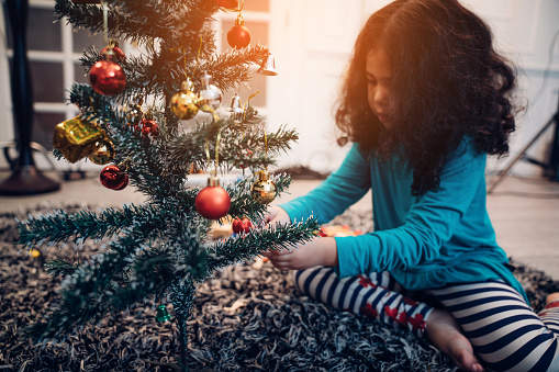 Close up of Kids decorating Christmas tree